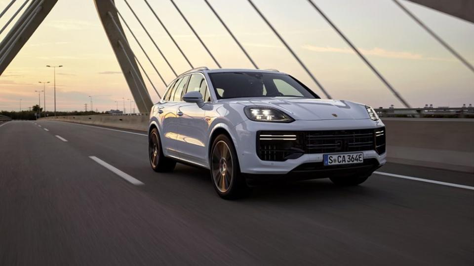 2024 porsche cayenne turbo ehybrid in white driving on a bridge