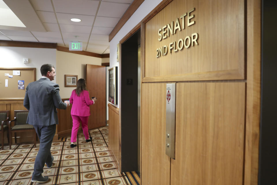 Staff enter the senate offices at the Oregon State Capitol in Salem, Ore., Thursday, May 4, 2023. Republican members of the Oregon Senate on Thursday extended their boycott of Senate proceedings into a second day, delaying action by the majority Democrats on bills on gun safety, abortion rights and gender-affirming health care. (AP Photo/Amanda Loman)