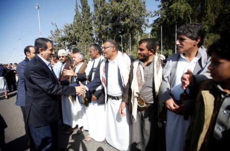 Members of the Houthi delegation participating in the peace talks in Sweden shake hands with their supporters at Sanaa airport, Sanaa, Yemen December 14, 2018. REUTERS/Mohamed al-Sayaghi