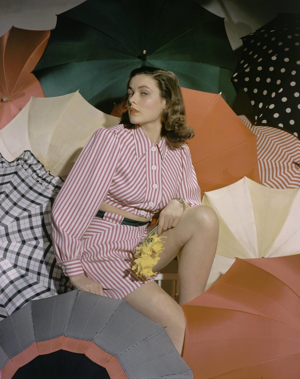 Actress Gene Tierney poses with colorful umbrellas in this undated photo.&nbsp;