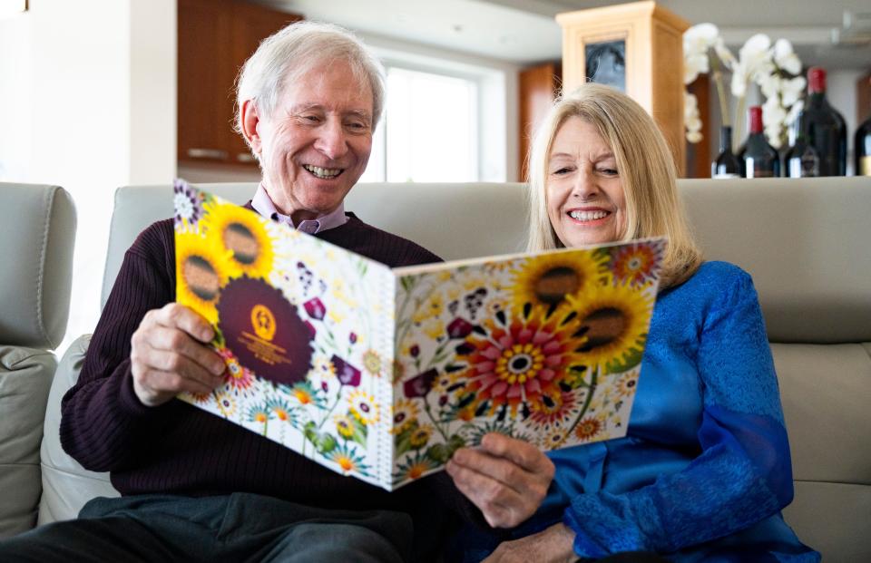 Brian and Denise Cobb reviewing the invitation to the 2024 Naples Winter Wine Festival.