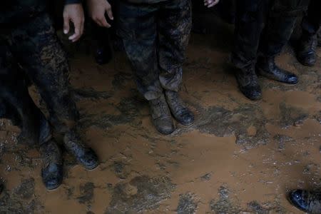 Soldiers line up near Tham Luang caves during a search for 12 members of an under-16 soccer team and their coach, in the northern province of Chiang Rai, Thailand, June 27, 2018. REUTERS/Soe Zeya Tun