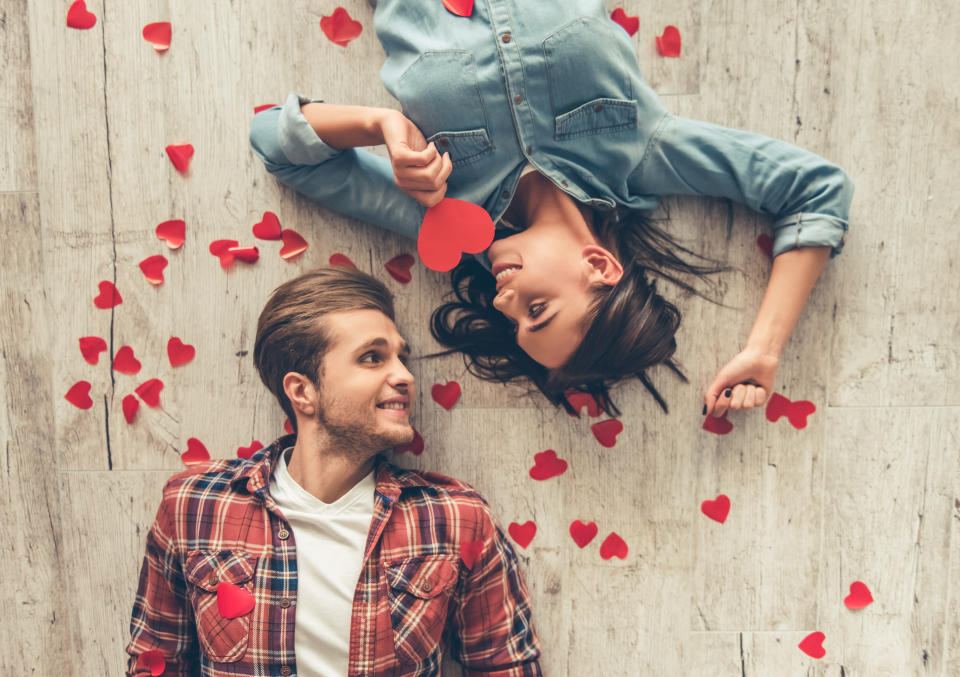 Happy young couple looking at each other and smiling on Valentine's Day