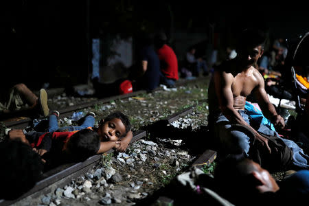 Members of a caravan of thousands of migrants from Central America en route to the U.S, rest after a clash with the Mexican Police near the border gate, with the intention to carry on their journey, in Tecun Uman, Guatemala, October 28, 2018. REUTERS/Carlos Garcia Rawlins