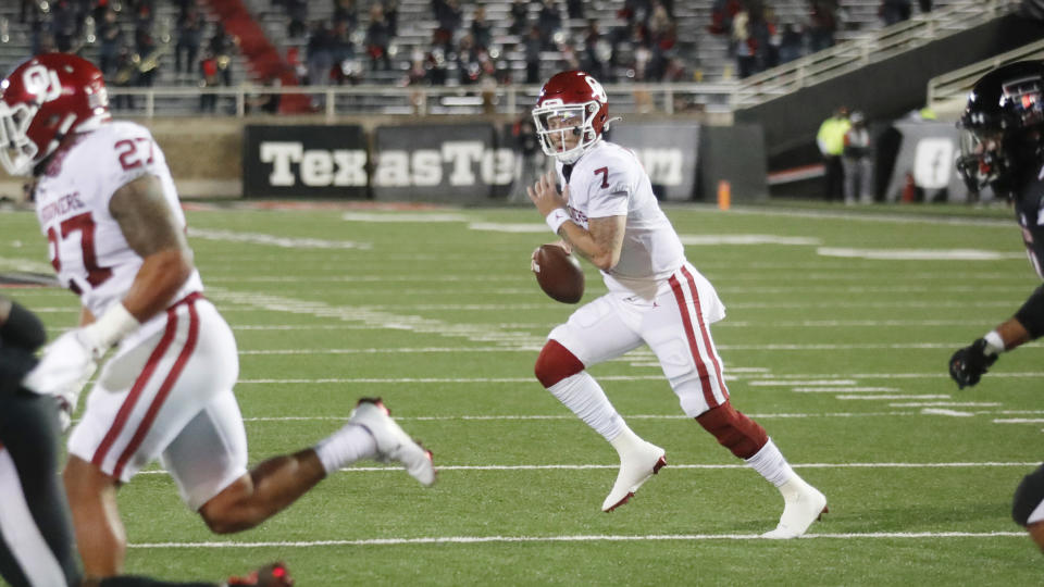 Oklahoma quarterback Spencer Rattler looks for an open receiver during the first half of the team's NCAA college football game against Texas Tech on Saturday, Oct. 31, 2020, in Lubbock, Texas. (AP Photo/Mark Rogers)