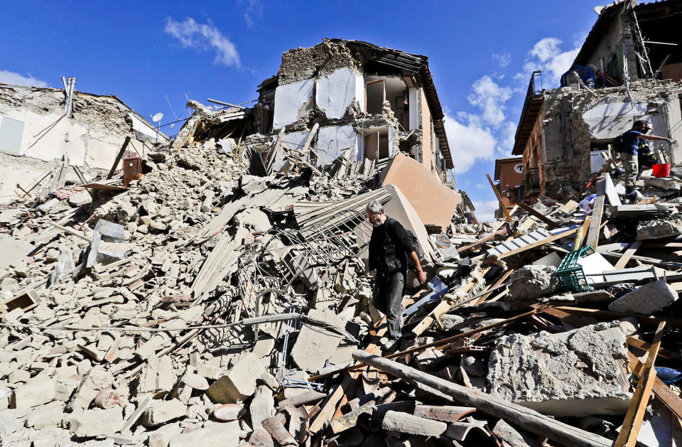 <p>A man walks amid rubble after an earthquake struck in Amatrice Italy, Aug. 24, 2016. The magnitude 6 quake struck at 3:36 a.m. (0136 GMT) and was felt across a broad swath of central Italy, including Rome where residents of the capital felt a long swaying followed by aftershocks. (Photo: Alessandra Tarantino/AP) </p>