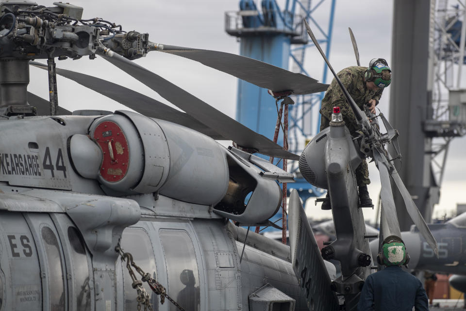 A marine prepares a helicopter on the deck of the Wasp-class amphibious assault ship USS Kearsarge, during the ship's welcome ceremony at the seaport of Klaipeda, Lithuania, Monday, Aug. 22, 2022. The Wasp-class amphibious assault ship USS Kearsarge (LHD 3), flagship of the Kearsarge Amphibious Ready Group and 22nd Marine Expeditionary Unit, arrived in Klaipeda, Lithuania for a scheduled port visit, Aug. 20, 2022. The ship's presence in Lithuania builds on the strong and enduring relationship the United States shares with the Baltic country, showing NATO solidarity and unity. (AP Photo/Mindaugas Kulbis)