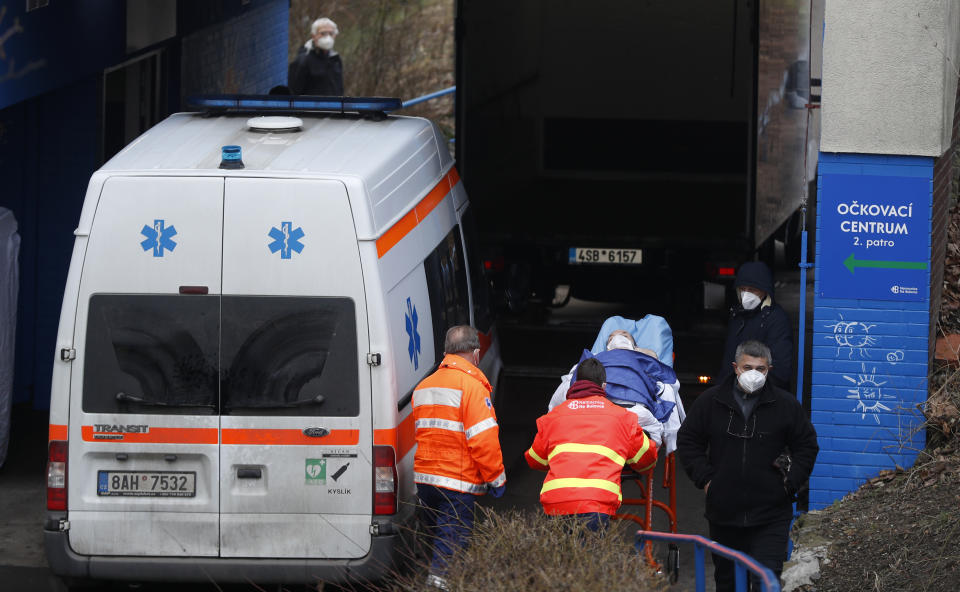 Healthcare workers move a patient to the infectious ward of the Bulovka hospital in Prague, Czech Republic, Wednesday, Feb. 24, 2021. The Czech prime minister Andrej Babis said the pandemic situation in one of the hardest-hit country in the European Union, is "extremely serious" and his government will have to impose more restrictive measures to slow down the spread of the coronavirus. (AP Photo/Petr David Josek)