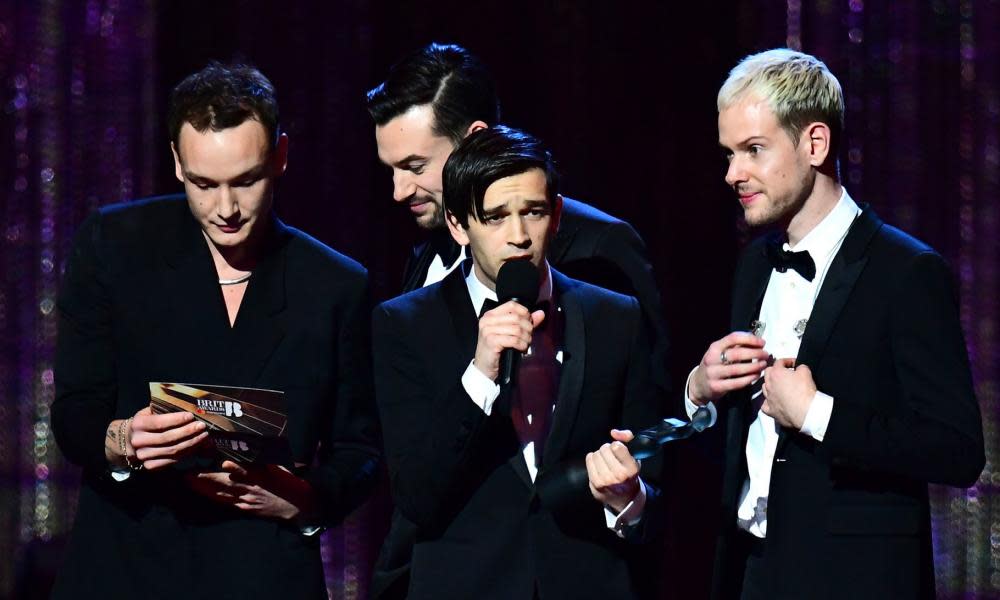 The 1975 accept the award for British album of the year.