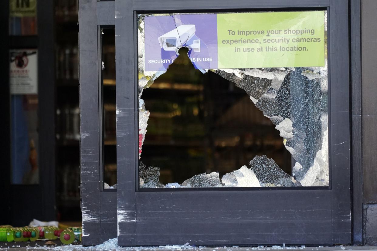 A door with broken glass stands open in the entrance of a Kroger grocery store Friday, Sept. 24, in Collierville, Tenn. 