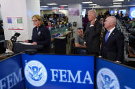 President Joe Biden and Homeland Security Secretary Alejandro Mayorkas listen as FEMA Administrator Deanne Criswell speaks during a briefing about Hurricane Ian at FEMA headquarters, Thursday, Sept. 29, 2022, in Washington. (AP Photo/Evan Vucci)