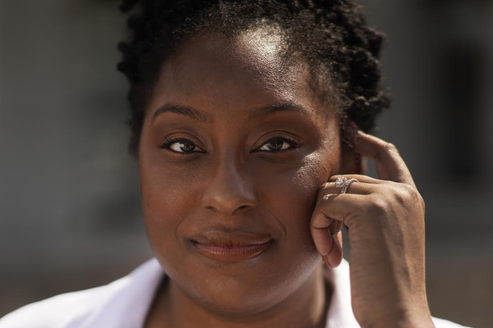 Dr. Brittani James poses for a portrait in the Bronzeville neighborhood of Chicago, Sunday, May 2, 2021. Surrounded by rich white kids and professors in medical school, James struggled. ‘’It was this huge feeling like I don’t belong here. None of the professors look like you, what you’re learning about people like you is racist and you’re getting tested on it.’’ (AP Photo/Charles Rex Arbogast)