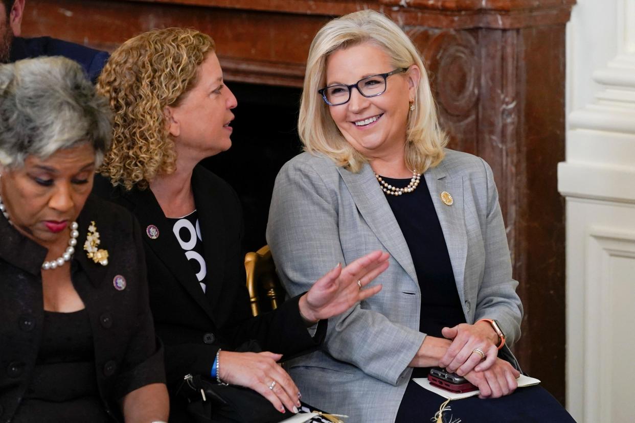 Sen. Liz Cheney, R-Wyo., talks with Rep. Debbie Wasserman Schultz, D-Fla., as they arrive to attend a ceremony to award the nation's highest civilian honor, the Presidential Medal of Freedom, former Sen. Joe in the East Room of the White House in Washington, Thursday, July 7, 2022. (AP Photo/Susan Walsh) ORG XMIT: DCSW403