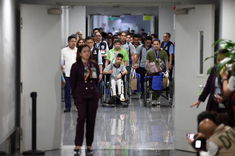 Filipino seafarers who survived the deadly Houthi attack on the commercial ship True Confidence arrive at Manila International Airport