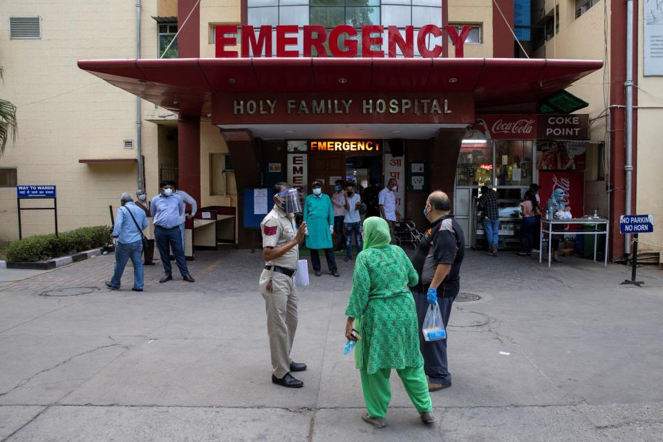 Relatives of a patient suffering with COVID-19 argue with a police officer over admittance to the emergency ward at Holy Family Hospital in New Delhi, India, May 1, 2021. / Credit: DANISH SIDDIQUI/REUTERS