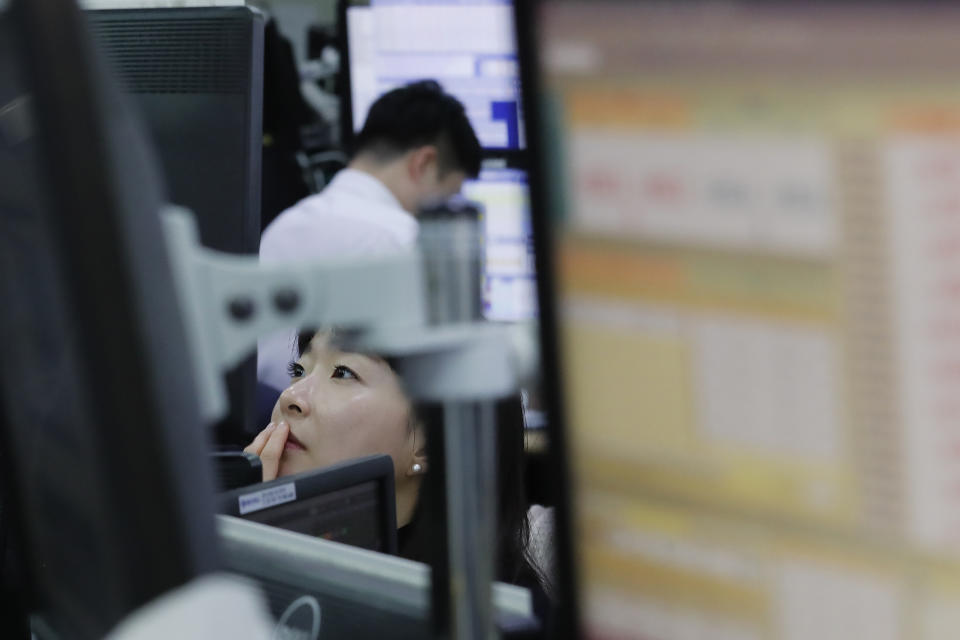 A currency trader watches monitors at the foreign exchange dealing room of the KEB Hana Bank headquarters in Seoul, South Korea, Wednesday, Dec. 4, 2019. Asian stock markets followed Wall Street lower after President Donald Trump cast doubt over the potential for a trade deal with China this year. (AP Photo/Ahn Young-joon)