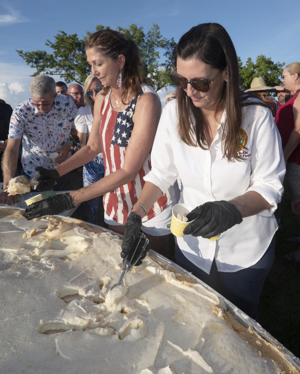 In this photo provided by the Florida Keys News Bureau, from left to right, Monroe County Commissioners Jim Scholl and Michelle Lincoln, along with Florida Lt. Governor Jeanette Nunez, serve Key lime pie to attendees at a 200th Florida Keys birthday celebration Monday, July 3, 2023, on Big Pine Key, Fla. The festivities marked the anniversary of the Florida Territorial Legislature’s establishment of Monroe County on July 3, 1823, and celebrated its history. (Andy Newman/Florida Keys News Bureau via AP)