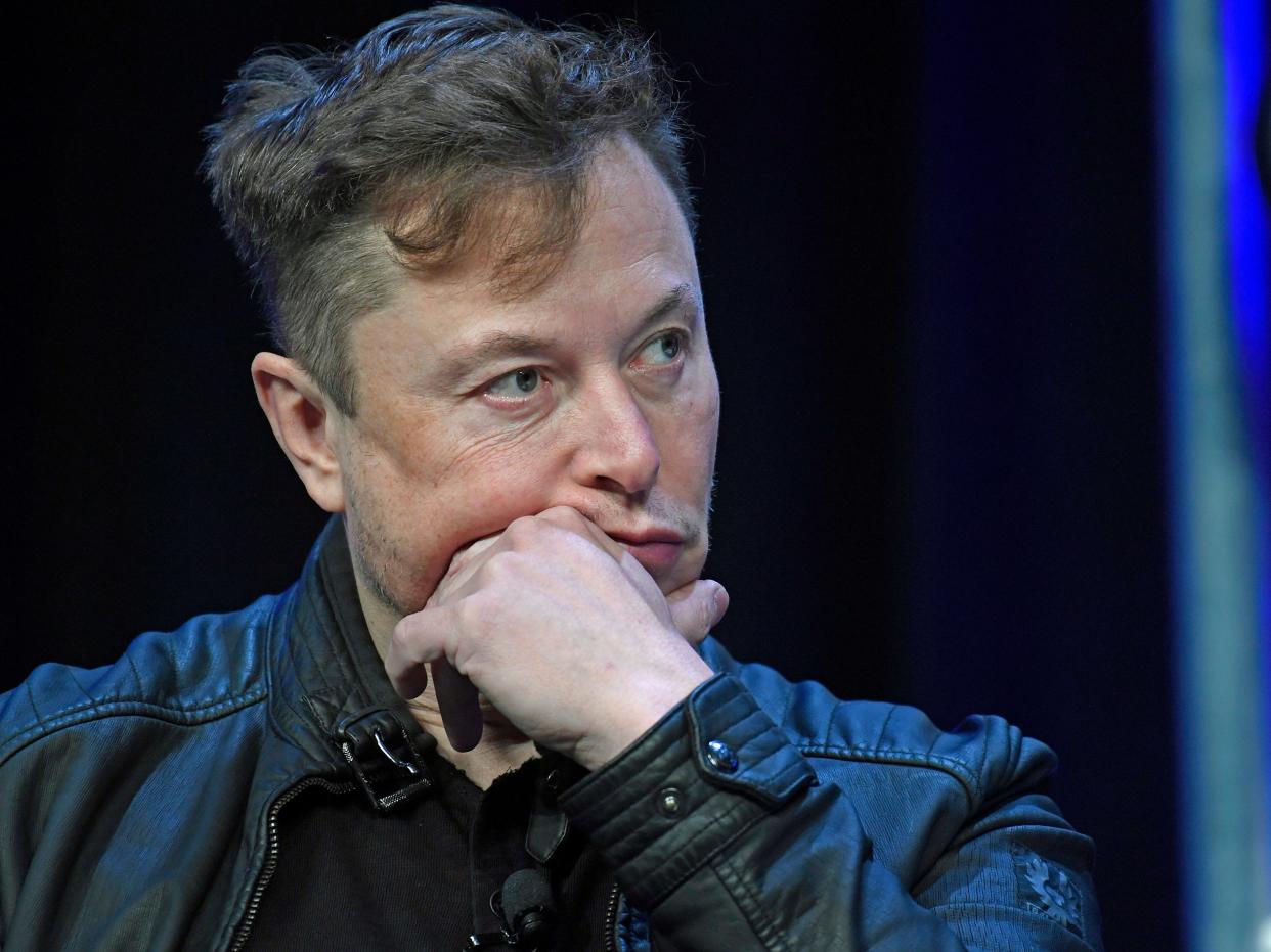 Elon Musk SpaceX Tesla CEO holds hand to face thinking