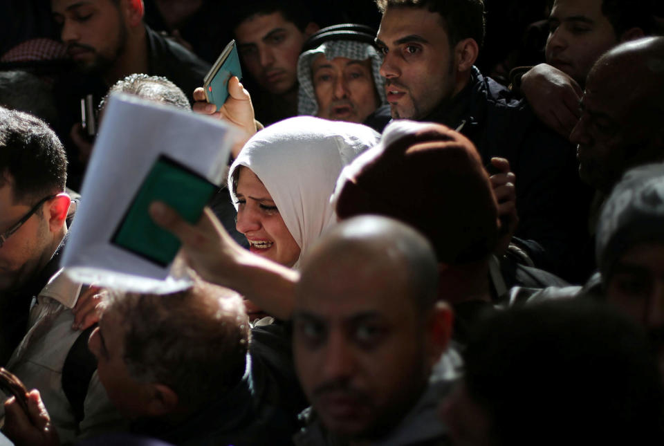 <p>A woman cries as she asks for a travel permit to cross into Egypt through the Rafah border crossing after it was opened by Egyptian authorities for humanitarian cases, in the southern Gaza Strip, Feb. 8, 2018. (Photo: Ibraheem Abu Mustafa/Reuters) </p>