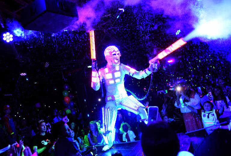 A dancer dressed as a robot performs during an electronic dance music party for children at a night club in New York on October 26, 2014