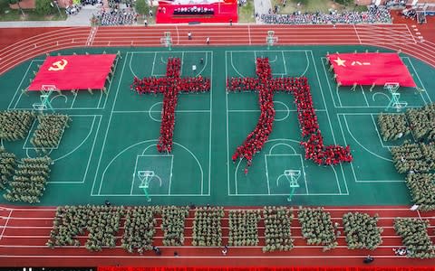 More than 600 young pioneers participate in a military parades to welcome the upcoming 19th National Congress - Credit: VCG