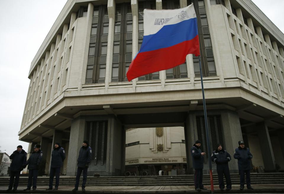 Police stand guard at a local parliament in Simferopol