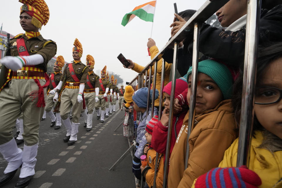 Children watch as Indian Border Security force soldiers march during the Republic Day parade in Lucknow, capital of northern Indian state of Uttar Pradesh, Friday, Jan. 26, 202. (AP Photo/Rajesh Kumar Singh)