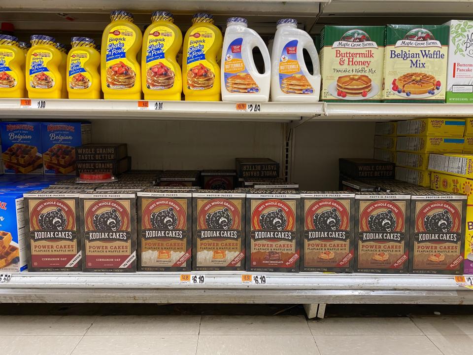two shelves at the grocery store filled with pancake mix