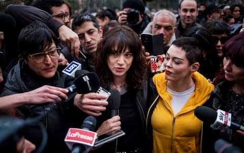 Italian actress Asia Argento(C) and Rose McGowan(R) take part in a demonstration organized by "Non una di meno" movement to mark the International Women's Day on March 8, 2018 in Rome, - Credit: Antonio Masiello/ Getty Images Contributor