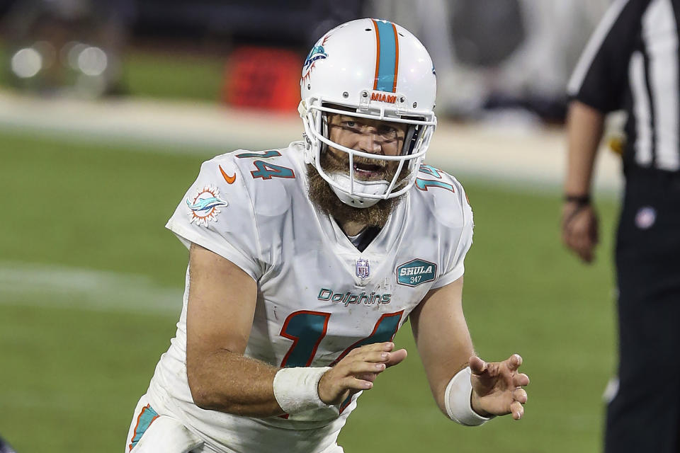 FILE - Miami Dolphins quarterback Ryan Fitzpatrick (14) waits for the snap during the second half of an NFL football game against the Jacksonville Jaguars in Jacksonville, Fla., in this Thursday, Sept. 24, 2020, file photo. Ryan Fitzpatrick has agreed to sign a one-year deal with Washington, according to a person with direct knowledge of the move. The person spoke to The Associated Press on condition of anonymity Tuesday, March 16, 2021, because the deal cannot be official until the new league year starts Wednesday. (AP Photo/Gary McCullough, File)