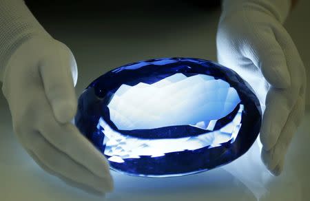 The largest known blue topaz stone, owned by philanthropist Maurice Ostro, is displayed to media at the Natural History Museum in London, Britain September 27, 2016. REUTERS/Peter Nicholls