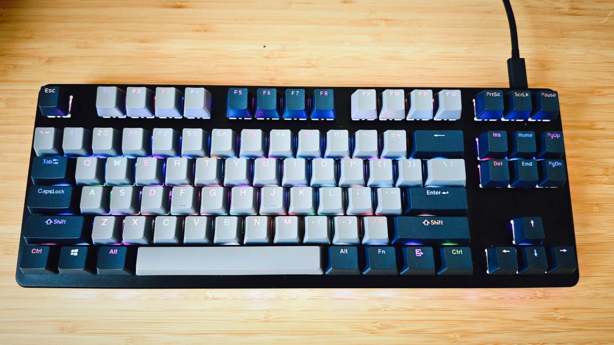  A black Drop CTRL V2 keyboard on a wooden desk. 