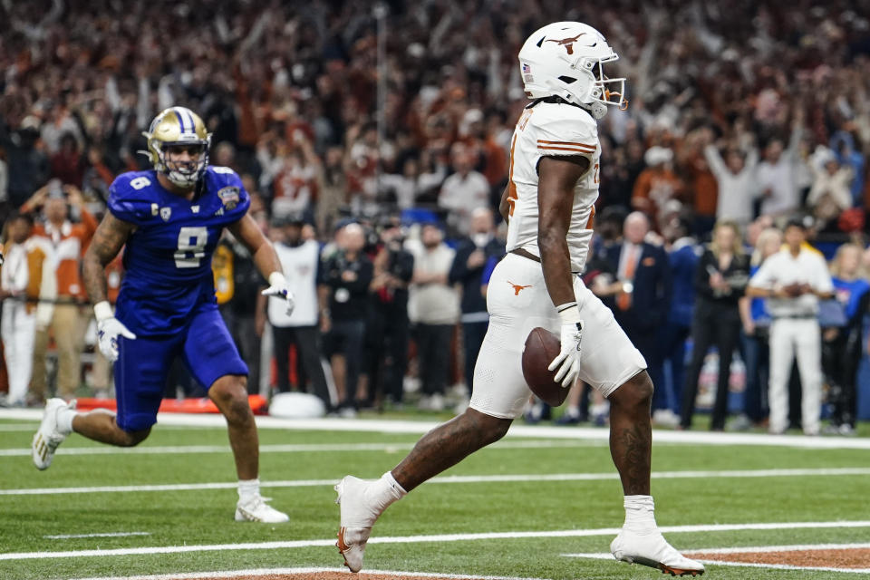 Texas running back CJ Baxter (4) scores a touchdown against Washington during the first half of the Sugar Bowl CFP NCAA semifinal college football game, Monday, Jan. 1, 2024, in New Orleans. (AP Photo/Jacob Kupferman)