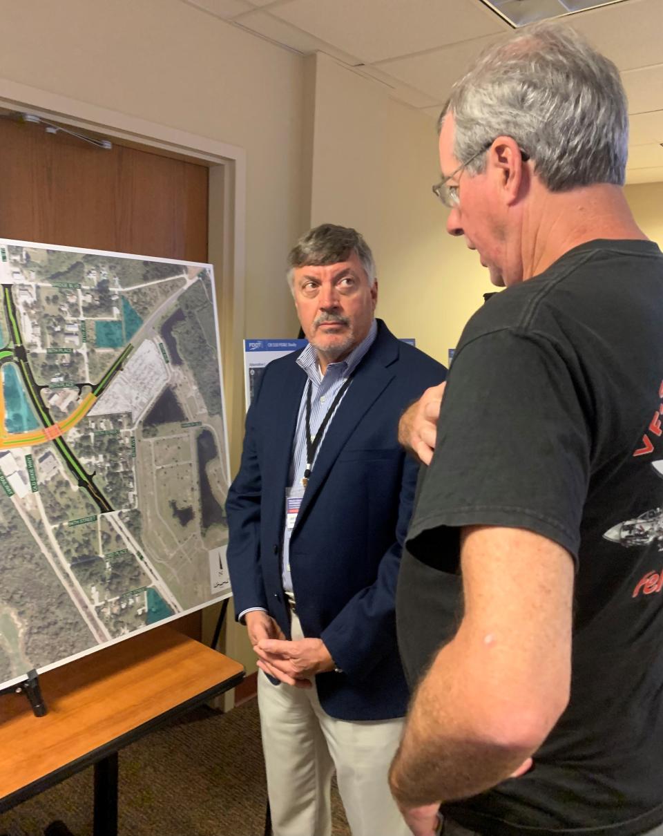 At an outreach meeting Thursday, Feb. 29, 2024, put on by the Florida Department of Transportation at the Indian River County Administration Building in Vero Beach, Jeff Bowen, left, of Hanson Professional Services, an engineering firm, listens as Bob Auwaerter, Indian River Shores council member, talks about potential grade separations, including a bridge over U.S. 1 for County Road 510, now in the planning stages. A final decision on the configuration is expected after public hearings later this year. Construction likely would not begin until at least the late 2020s.