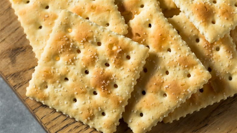 saltine crackers on cutting board