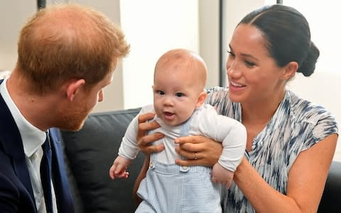 Prince Harry and his wife Meghan, Duchess of Sussex, holding their son Archie in Cape Town, South Africa - Credit: Dominic Lipinski/PA