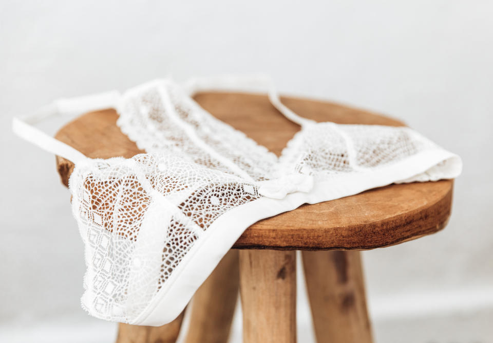 White delicate lace bra on a wood  stool