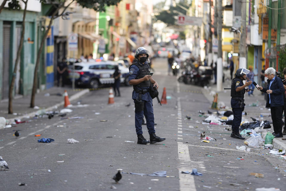 FILE - Policemen patrol a street in an area occupied by drug users known as Crackland, in downtown Sao Paulo, Brazil, Thursday, May 11, 2023. (AP Photo/Andre Penner, File)