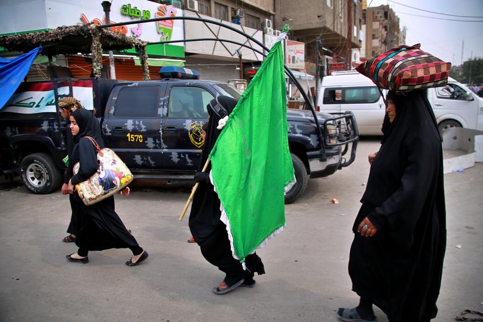 Although shrines are closed due to the new coronavirus, Shiite pilgrims make their way to the shrine of Imam Moussa al-Kadhim, a key Shiite saint, during preparations for the annual commemoration of his death, in Baghdad, Iraq Monday, March 16, 2020. Iraq announced a weeklong curfew late Sunday. People raced to supermarkets and swiftly emptied shelves, while others stocked up on cooking fuel. The curfew, which is set to begin late Tuesday, includes the suspension of all flights from Baghdad's international airport. For most people, the virus causes only mild or moderate symptoms. For some it can cause more severe illness. (AP Photo/Hadi Mizban)