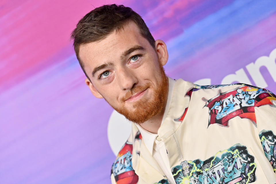 Angus smiling at the camera, wearing a printed shirt with a casual appearance