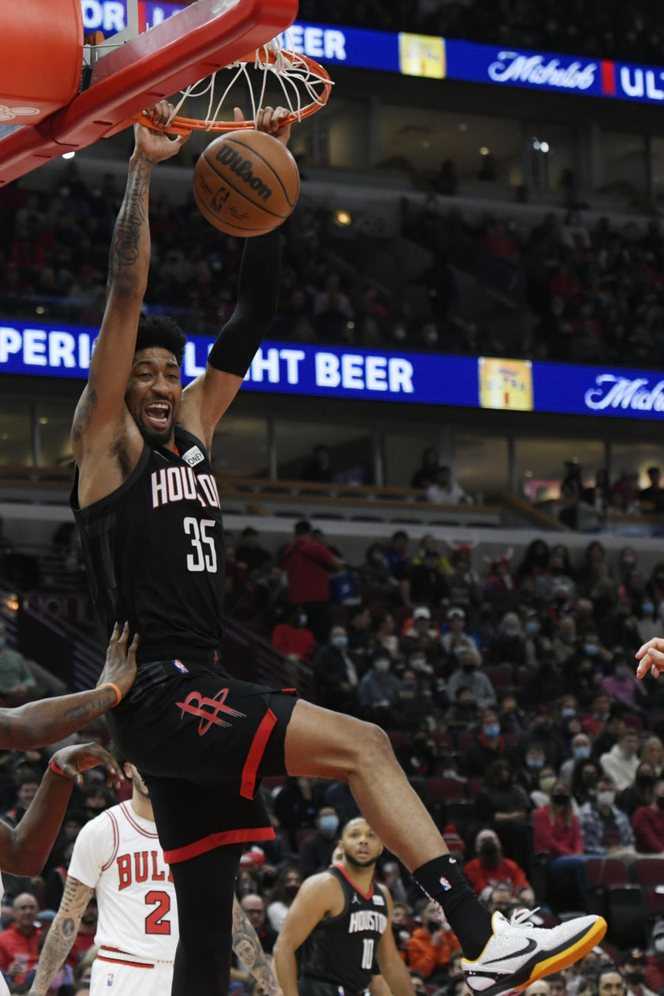 Houston Rockets center Christian Wood (35) dunks against Chicago Bulls forward Javonte Green during the first half of an NBA basketball game Monday, Dec. 20, 2021, in Chicago. (AP Photo/Paul Beaty)