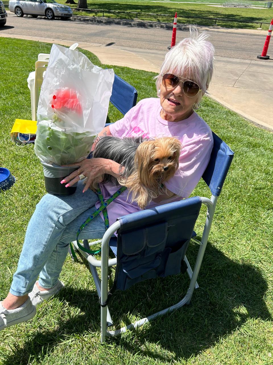 One of the spectators Saturday at Westminster Doggy Show holds her Yorkie and beautiful Geraniums purchased at the fun-raiser.