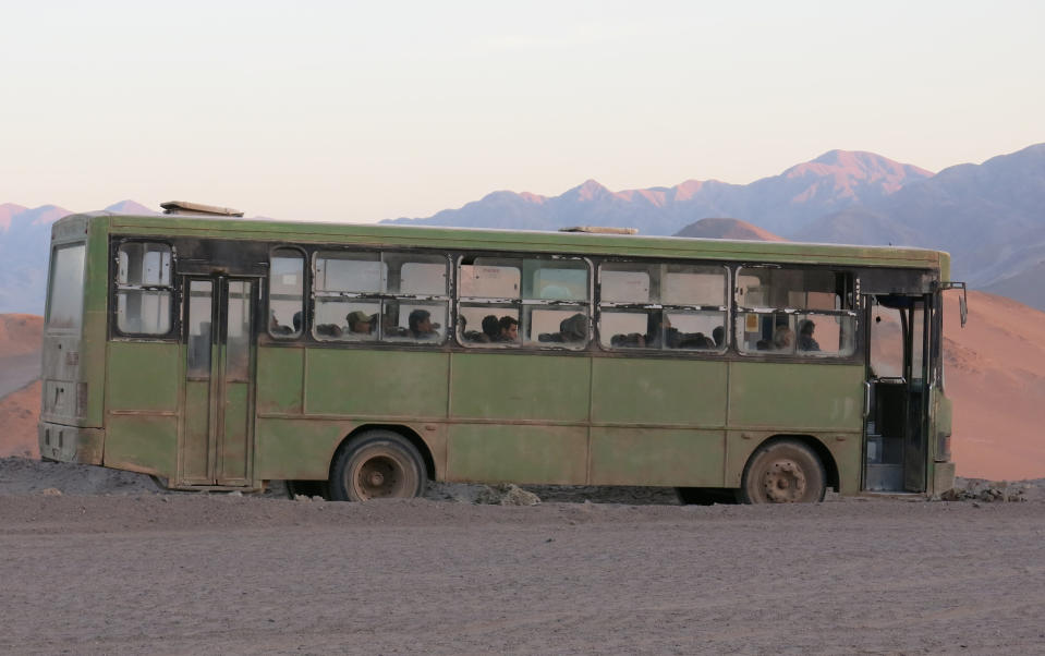 In this Feb. 11, 2014 photo, a bus sits in the desert on the set of the film "The 33" near Copiapo, Chile. The film dramatizes a cave-in that trapped 33 miners deep below Chile's Atacama desert for 69 days in 2010. Actors Juliette Binoche and Antonio Banderas are starring in the film based on the televised rescue that mesmerized millions of people around the globe. The movie is being shot in English and is expected to be released next year. (AP Photo/Eva Vergara)