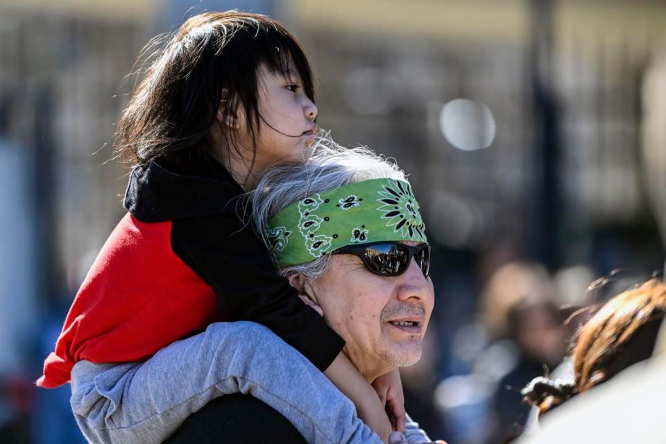 Joe Pulliam, of Rapid City, holds his 2-year-old son Akicitaas he came to show his support while listening to the speakers at the Andrew W. Bogue Federal building on Wednesday afternoon where it was announced that a federal civil rights lawsuit was filed against the Grand Gateway Hotel on North Lacrosse Street for denying services to Native Americans. The rally comes just four days after a shooting early Saturday morning at the Grand Gateway Hotel on North Lacrosse Street.