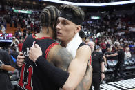 Chicago Bulls guard DeMar DeRozan (11) and Miami Heat guard Tyler Herro congratulate each other after the Heat beat the Bulls 112-91 in an NBA basketball play-in tournament game, Friday, April 19, 2024, in Miami. (AP Photo/Wilfredo Lee)