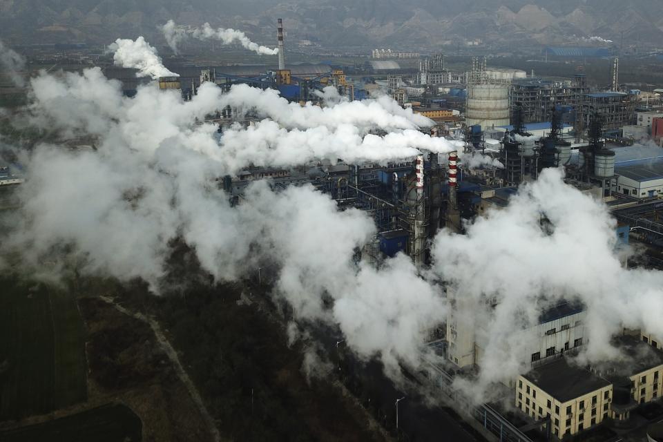 Smoke and steam rise from a coal processing plant that produces carbon black, an ingredient in steel manufacturing, in Hejin in central China's Shanxi Province.&nbsp; (Photo: AP Photo/Sam McNeil)