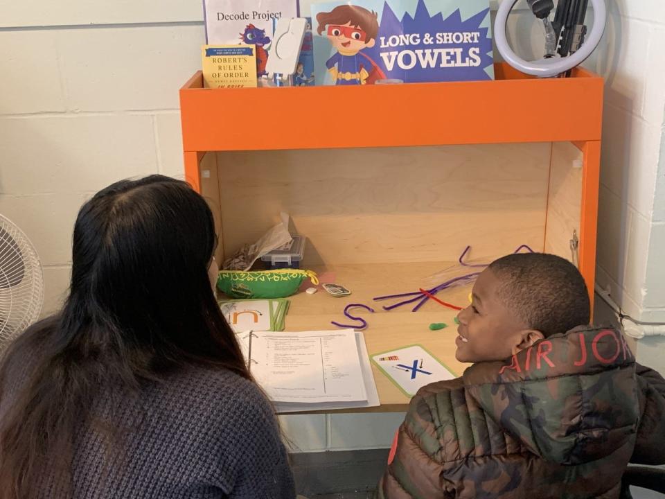 Kindergartener Carlos James practices saying the sounds of letters with literacy mentor Janica Ramientos at Decode Project.