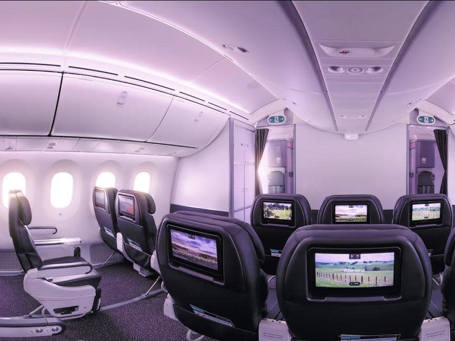 A row of premium economy seats aboard an Air New Zealand aircraft.