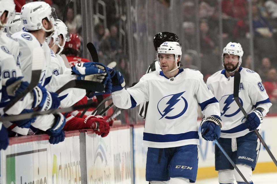 Tampa Bay Lightning center Brayden Point (21) greets teammates after scoring during the first period of an NHL hockey game against the Detroit Red Wings, Wednesday, Dec. 21, 2022, in Detroit. (AP Photo/Carlos Osorio)