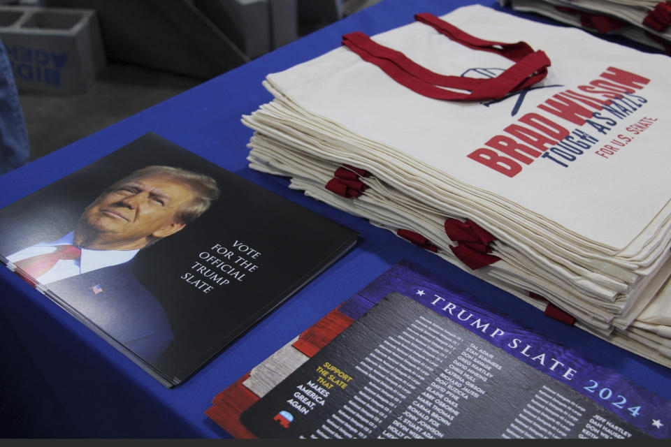 A campaign display for former Utah state House Speaker Brad Wilson, who is running for the U.S. Senate seat Mitt Romney is vacating, shows a tractor clearing away concrete blocks labeled "Biden Agenda" at the Utah Republican Party Convention, April 27, 2024, in Salt Lake City, Utah. (AP Photo/Hannah Schoenbaum)